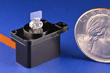rotary microstage shown with mirror mounted on shaft, next to a quarter for scale